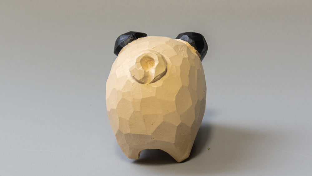 Puffed Pups: charming hand-carved wooden dog figurines with a signature playfully rounded style.