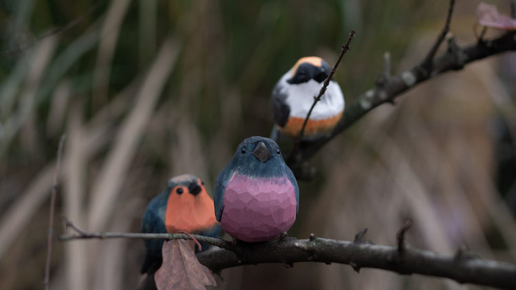 Hand-carved wooden bird figurines from the Nature’s Birds collection, inspired by real birds and wildlife.