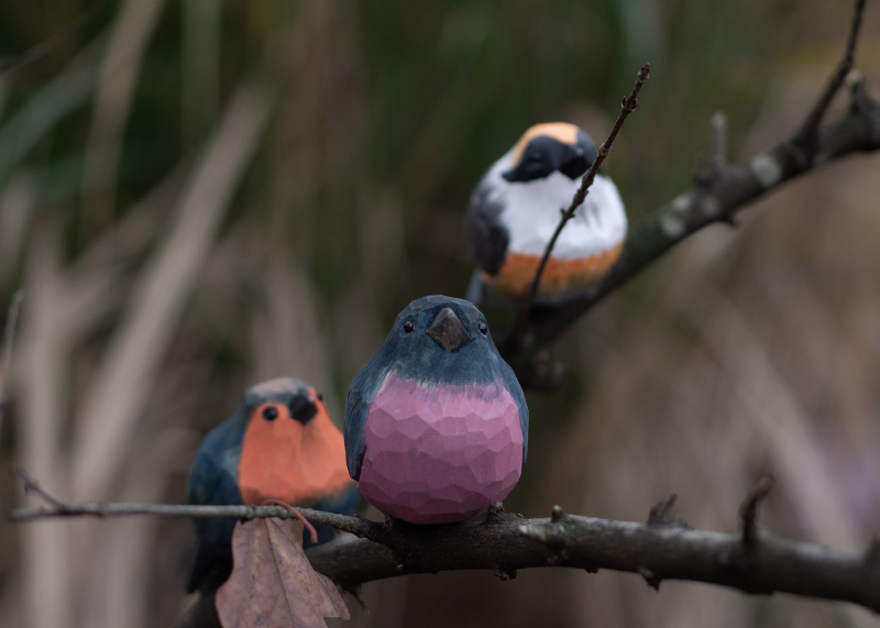 Hand-carved wooden bird figurines from the Nature’s Birds collection, inspired by real birds and wildlife.