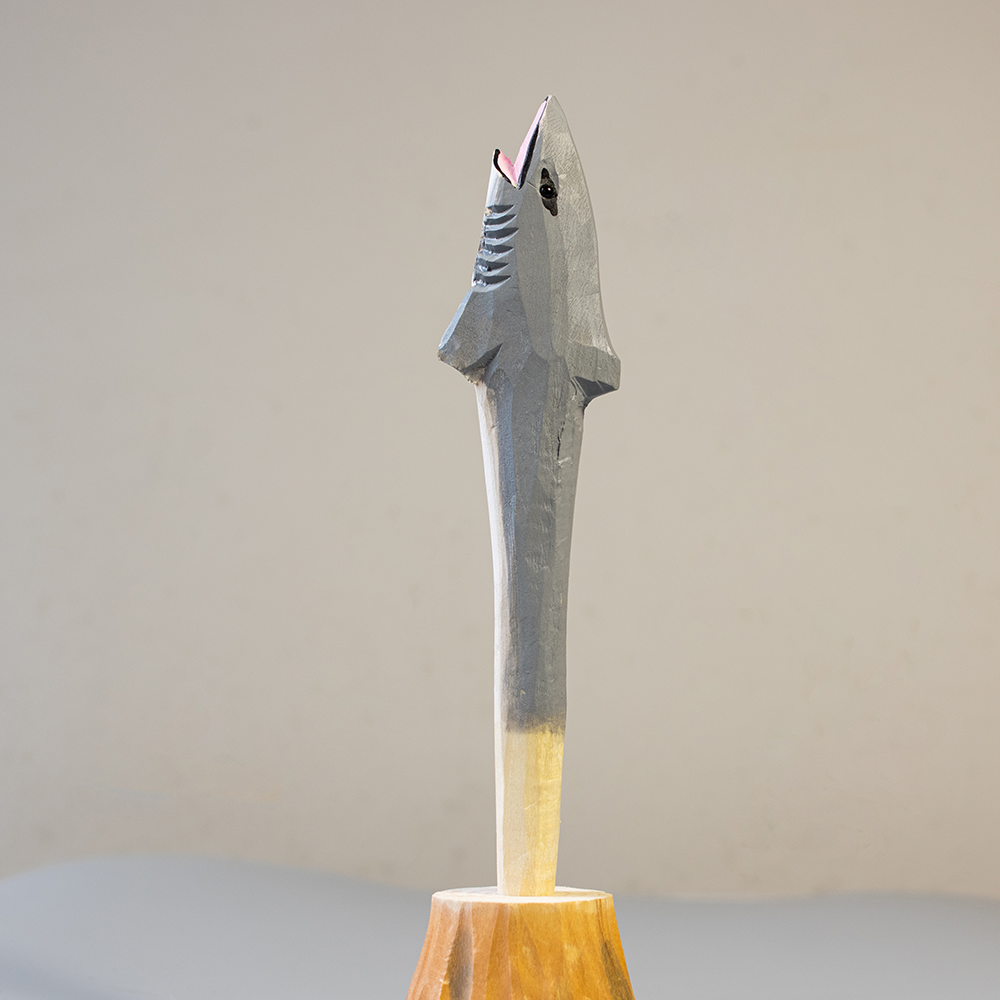 Handcrafted wooden great white shark pen on a plain background