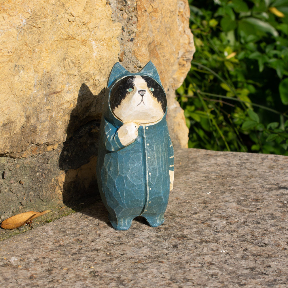 Hand-carved wooden figurine of a tuxedo cat in onesies, unique decor for cat enthusiasts.