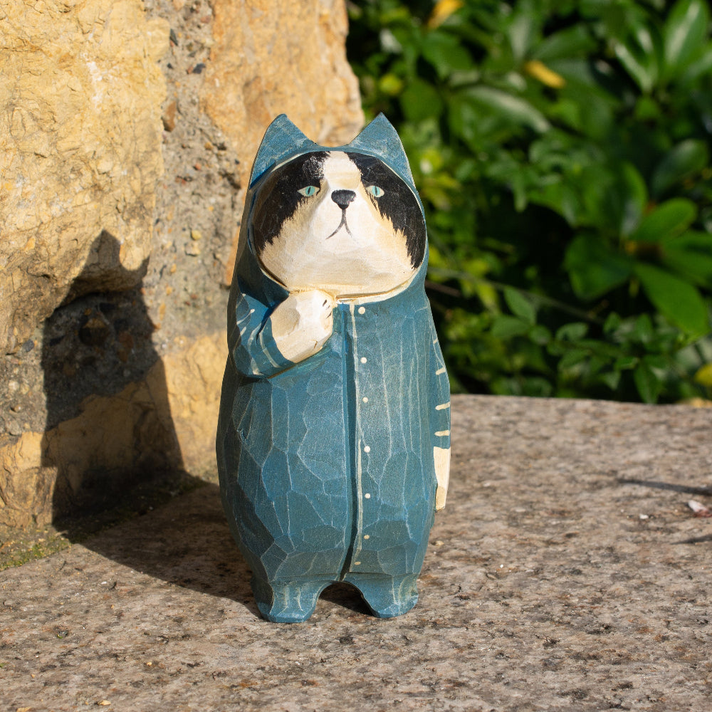 Hand-carved wooden figurine of a tuxedo cat in onesies, unique decor for cat enthusiasts.