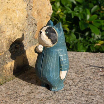 Hand-carved wooden figurine of a tuxedo cat in onesies, unique decor for cat enthusiasts.