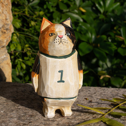 Hand-carved wooden figurine of a calico cat basketball player, ideal for sports fans and cat lovers.