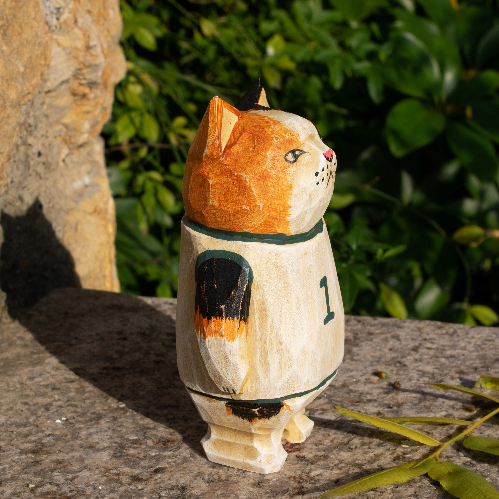 Hand-carved wooden figurine of a calico cat basketball player, ideal for sports fans and cat lovers.