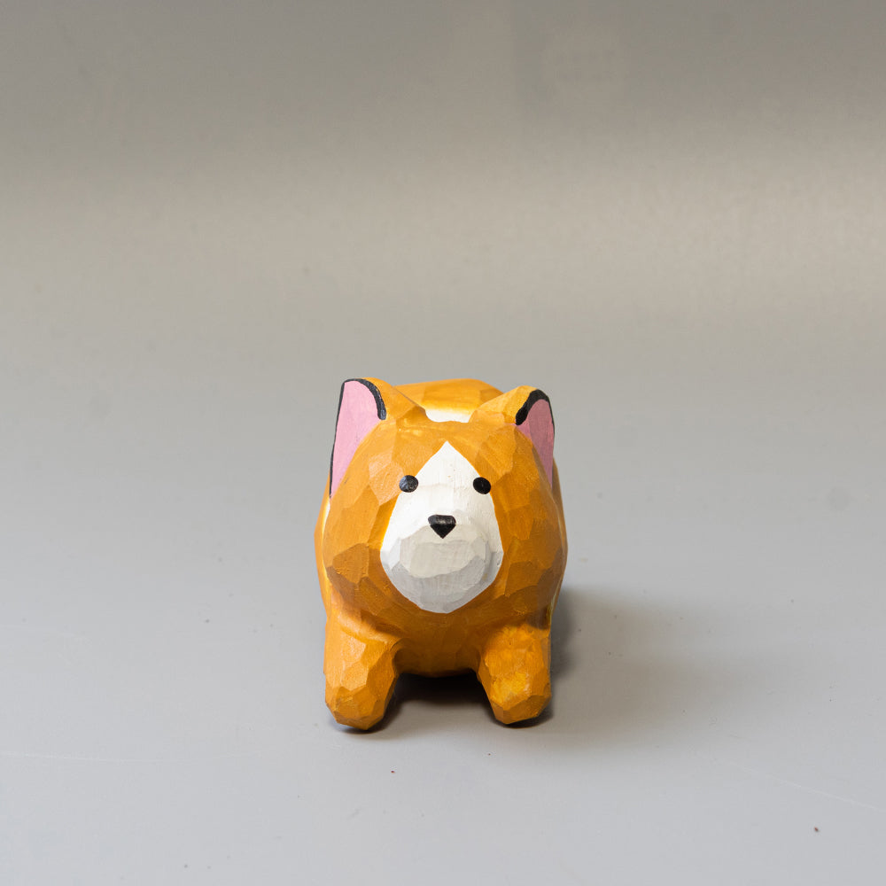 Hand-carved wooden Corgi figurine in a playful 'sploot' running pose. An energetic wood dog figure. 