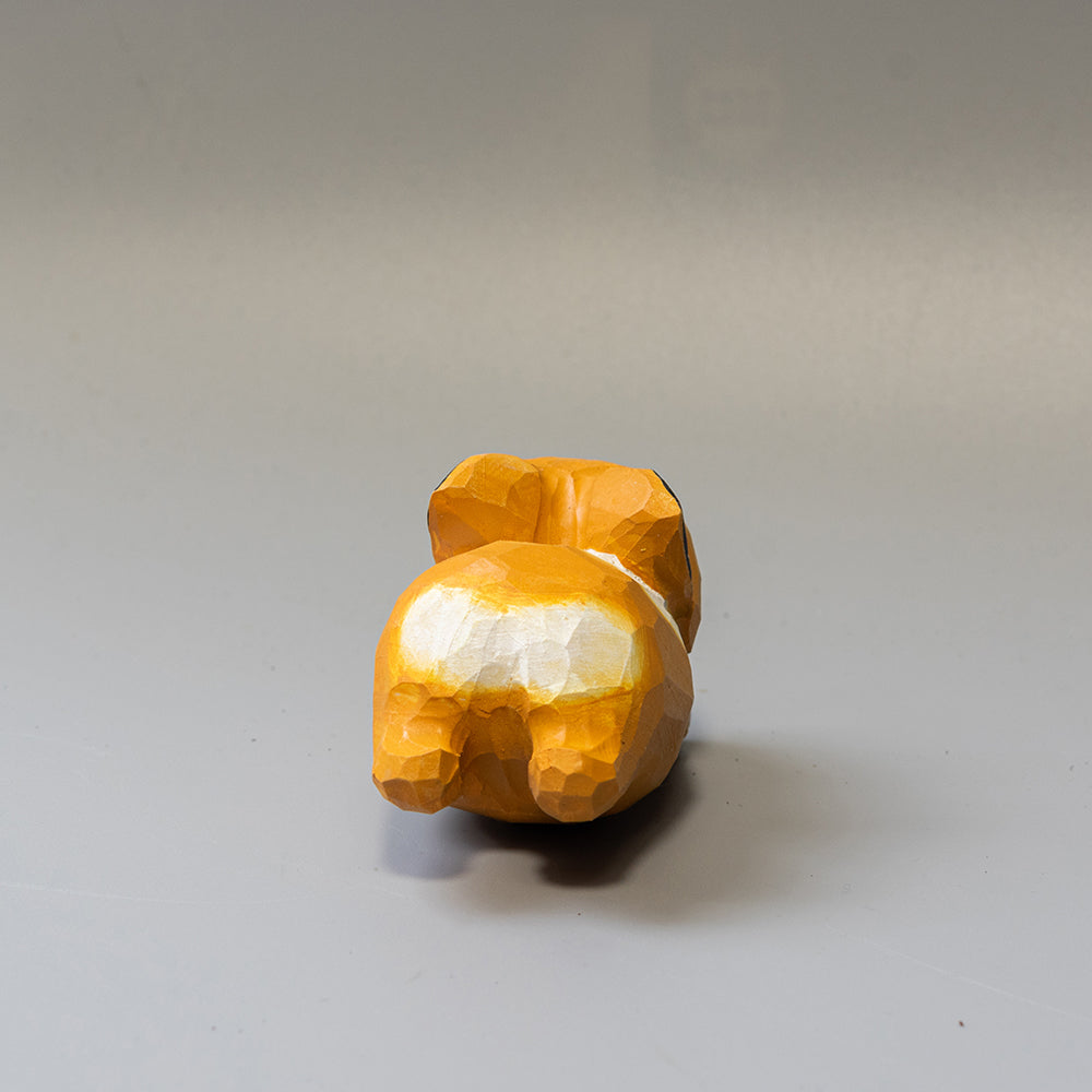 Hand-carved wooden Corgi figurine in a playful 'sploot' running pose. An energetic wood dog figure. 