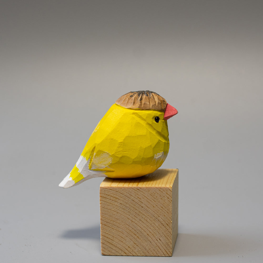 Hand-carved wooden Crested Canary figurine in bright yellow with a distinct feathered crest. 