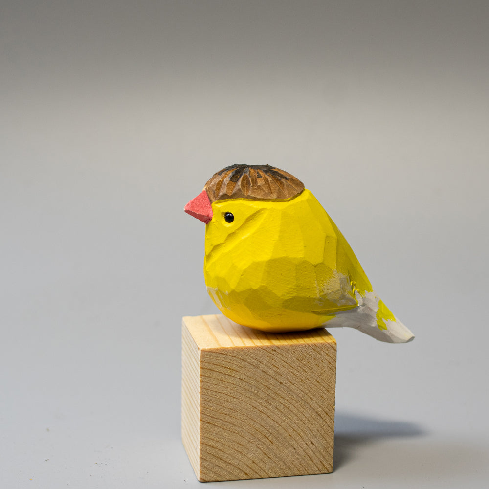 Hand-carved wooden Crested Canary figurine in bright yellow with a distinct feathered crest. 