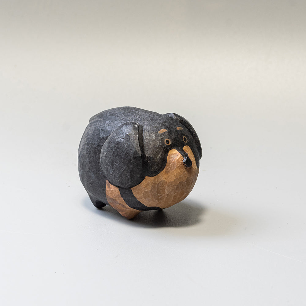 Hand-carved wooden Dachshund figurine from the Puffed Pups series. A cute, rounded wood carving by Woorai. 