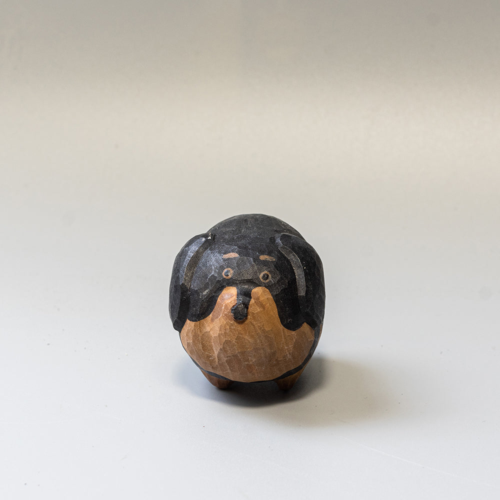 Hand-carved wooden Dachshund figurine from the Puffed Pups series. A cute, rounded wood carving by Woorai. 
