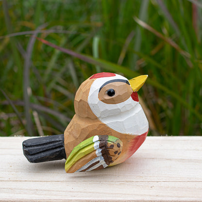 Detailed wooden goldfinch figurine with bright yellow and black coloring, hand-carved for unique decor.