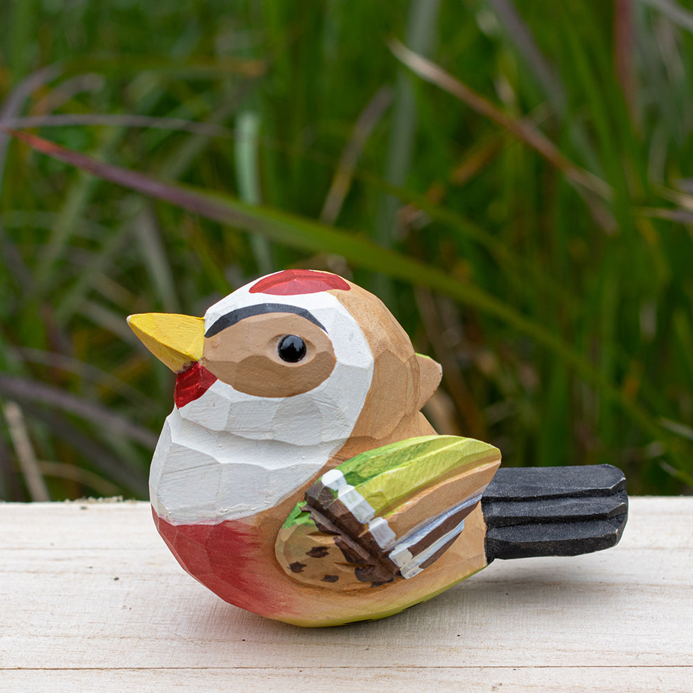 Detailed wooden goldfinch figurine with bright yellow and black coloring, hand-carved for unique decor.