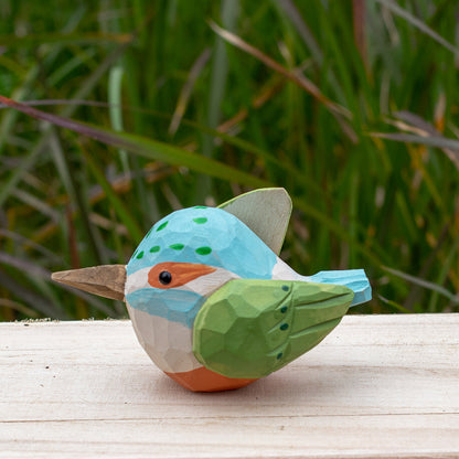 Hand-carved wooden kingfisher bird figurine with vibrant blue and green details from the Odd Flocks collection.