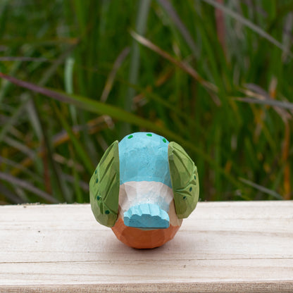 Hand-carved wooden kingfisher bird figurine with vibrant blue and green details from the Odd Flocks collection.