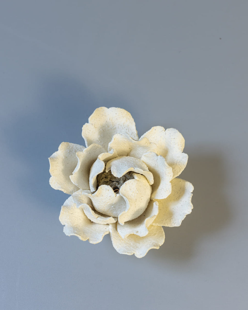 White ceramic incense holder on a white asurface.