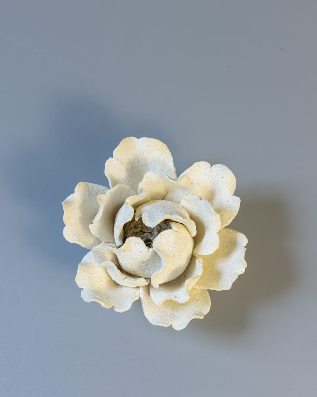 White ceramic incense holder on a white asurface.