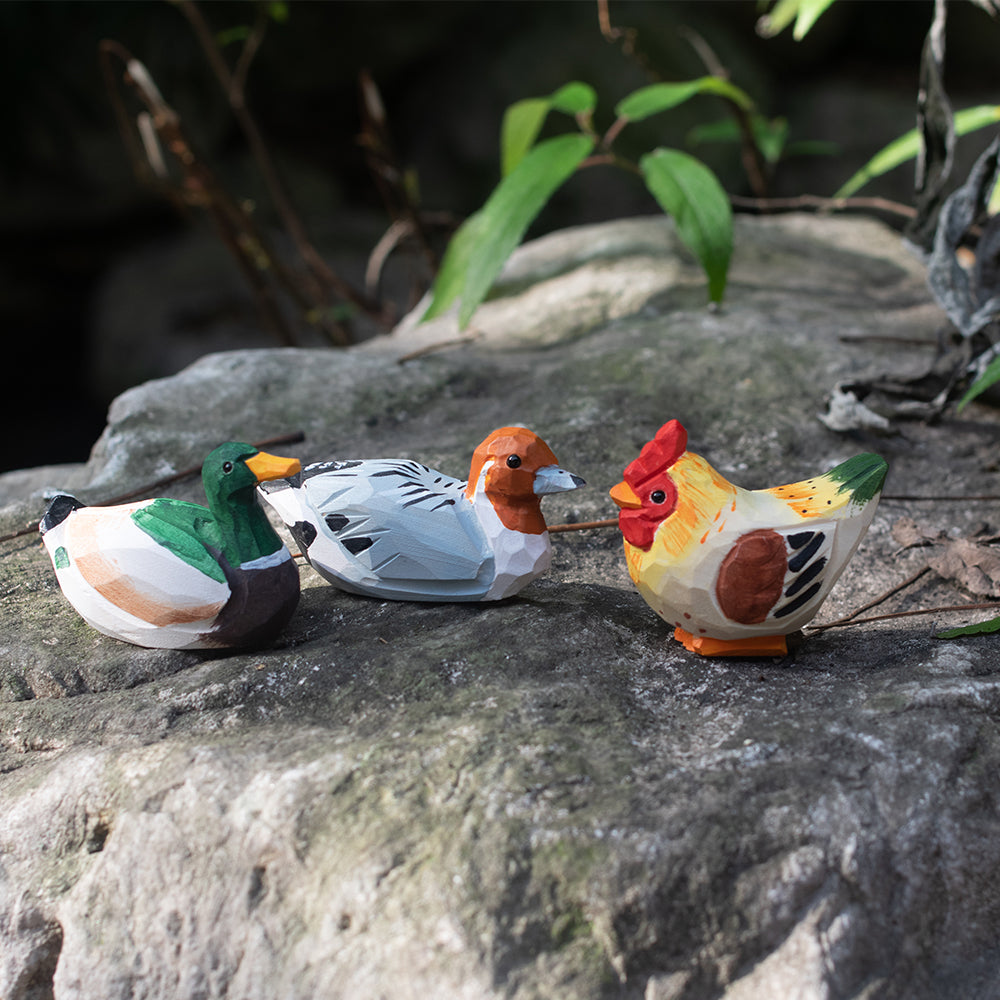 A set of hand-carved wooden figurines, featuring a mallard, barnyard hen, and rustic duck. Free shipping for orders over $69.