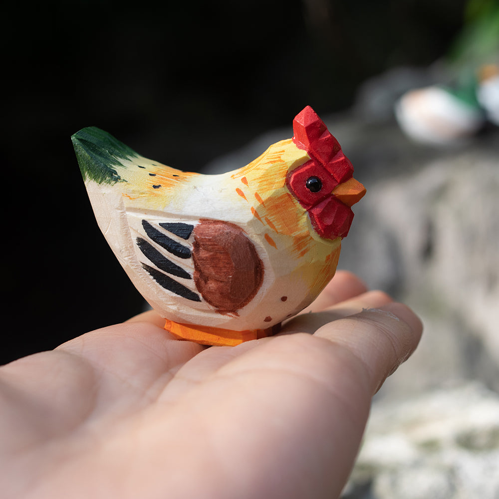 A hand-carved wooden figurines of a  barnyard hen. 