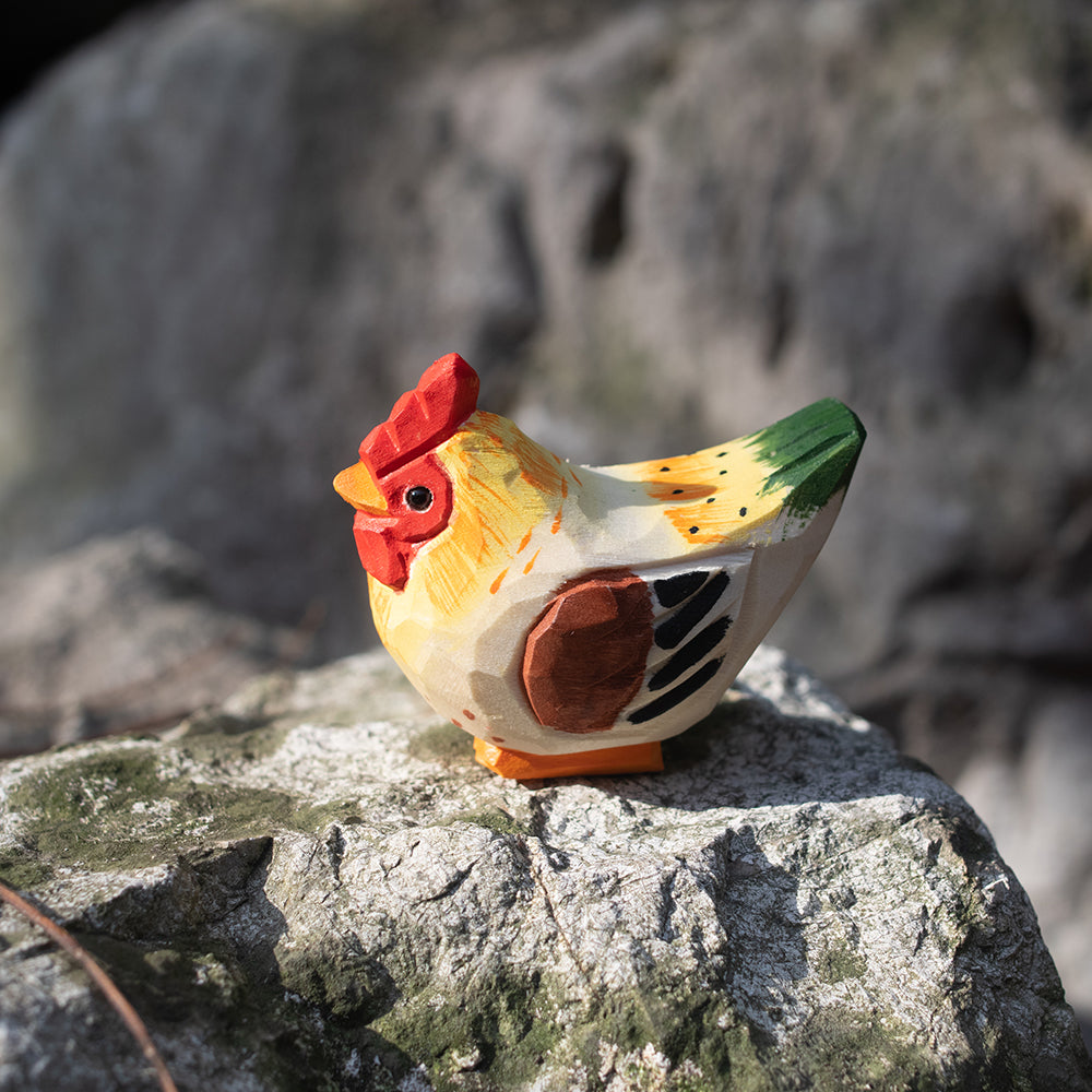 A hand-carved wooden figurines of a  barnyard hen. 