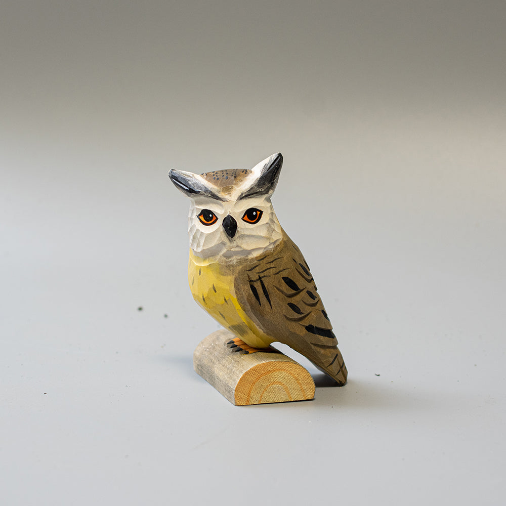 Hand carved wooden Northern White Faced Owl figurine with white facial disk and ear tufts, on a wood base. 