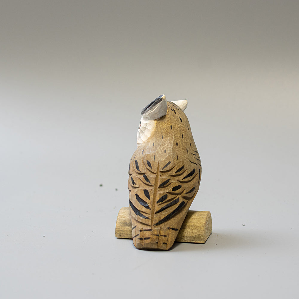 Hand carved wooden Northern White Faced Owl figurine with white facial disk and ear tufts, on a wood base. 