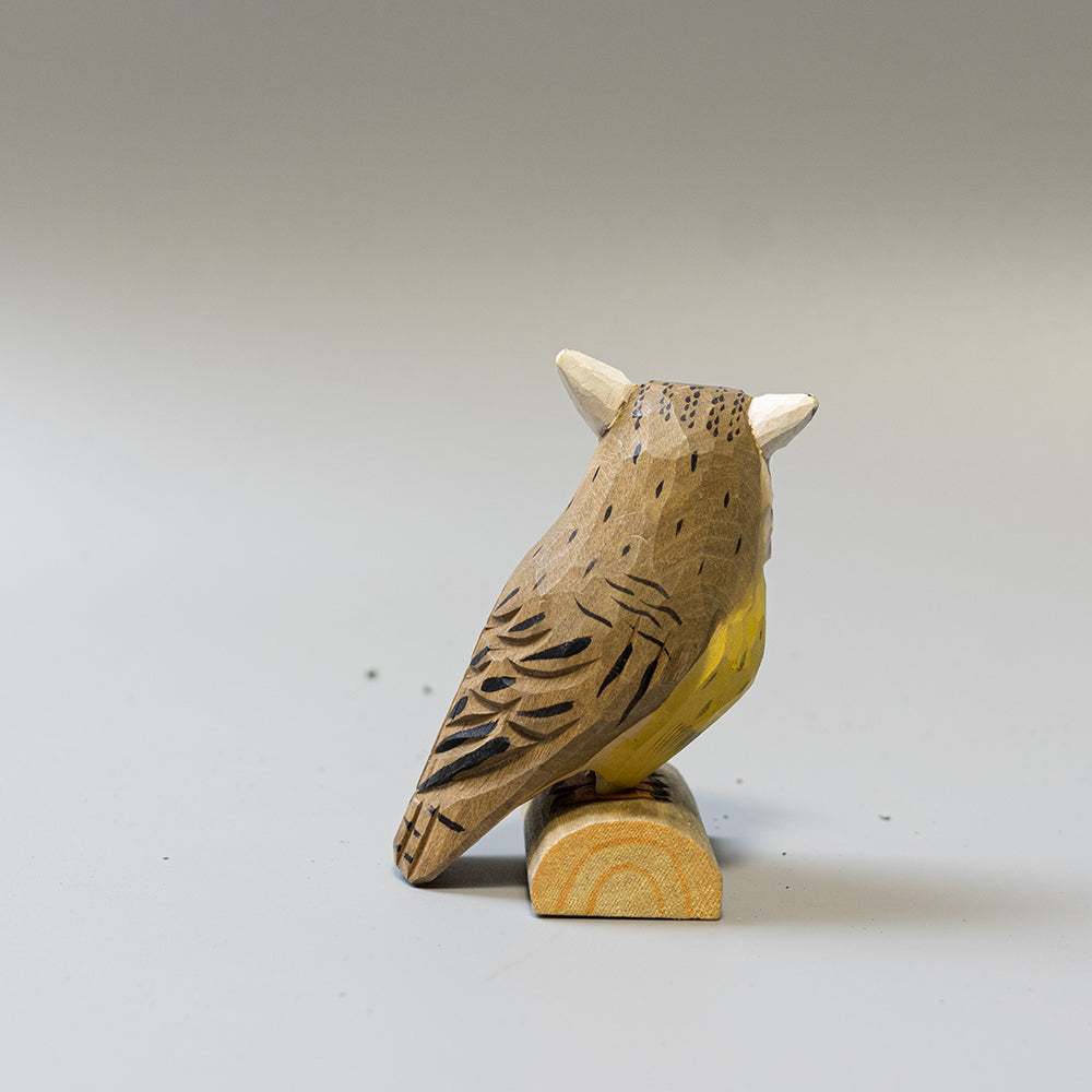 Hand carved wooden Northern White Faced Owl figurine with white facial disk and ear tufts, on a wood base. 