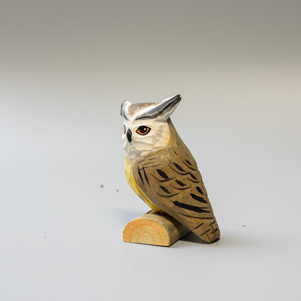 Hand carved wooden Northern White Faced Owl figurine with white facial disk and ear tufts, on a wood base. 