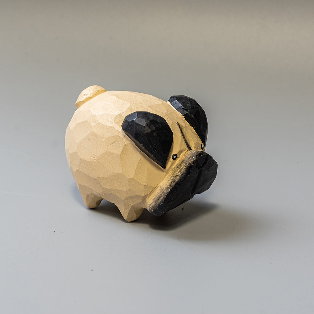 Hand-carved wooden Pug figurine with artfully rounded wrinkles and curled tail. 