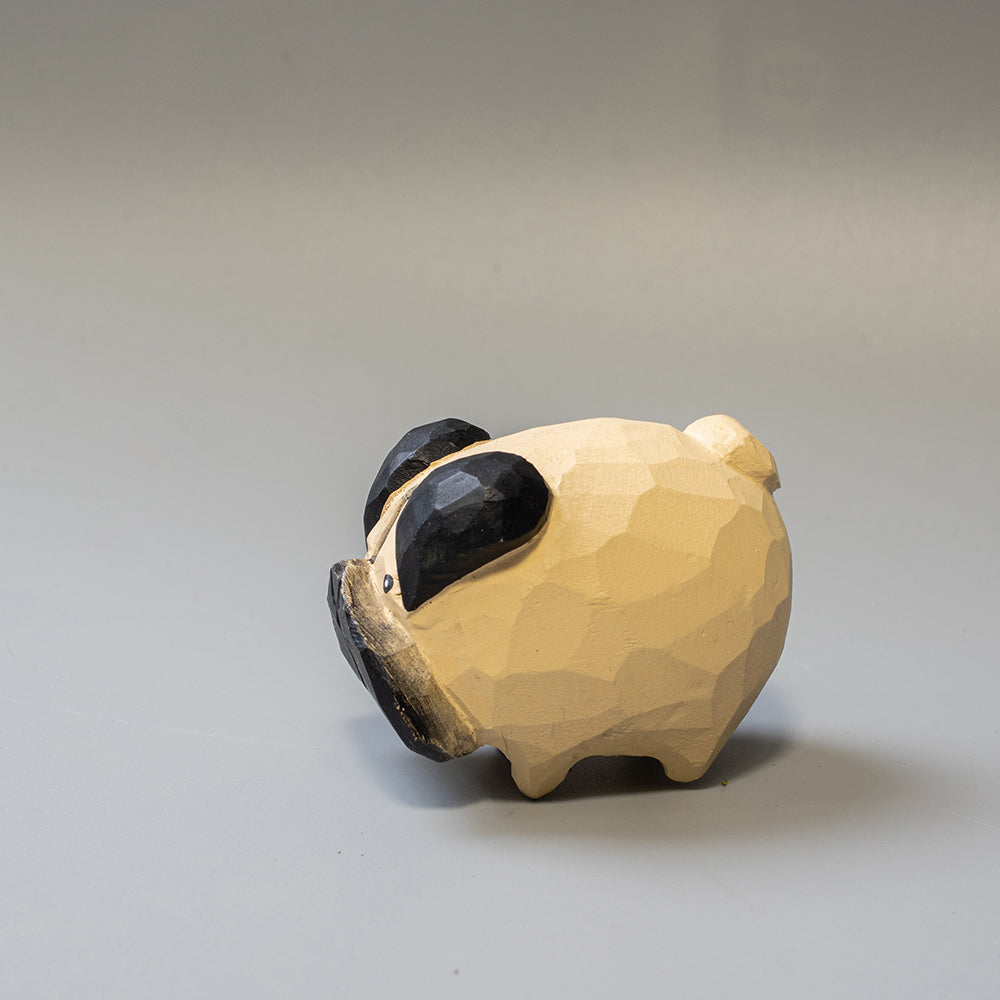 Hand-carved wooden Pug figurine with artfully rounded wrinkles and curled tail. 