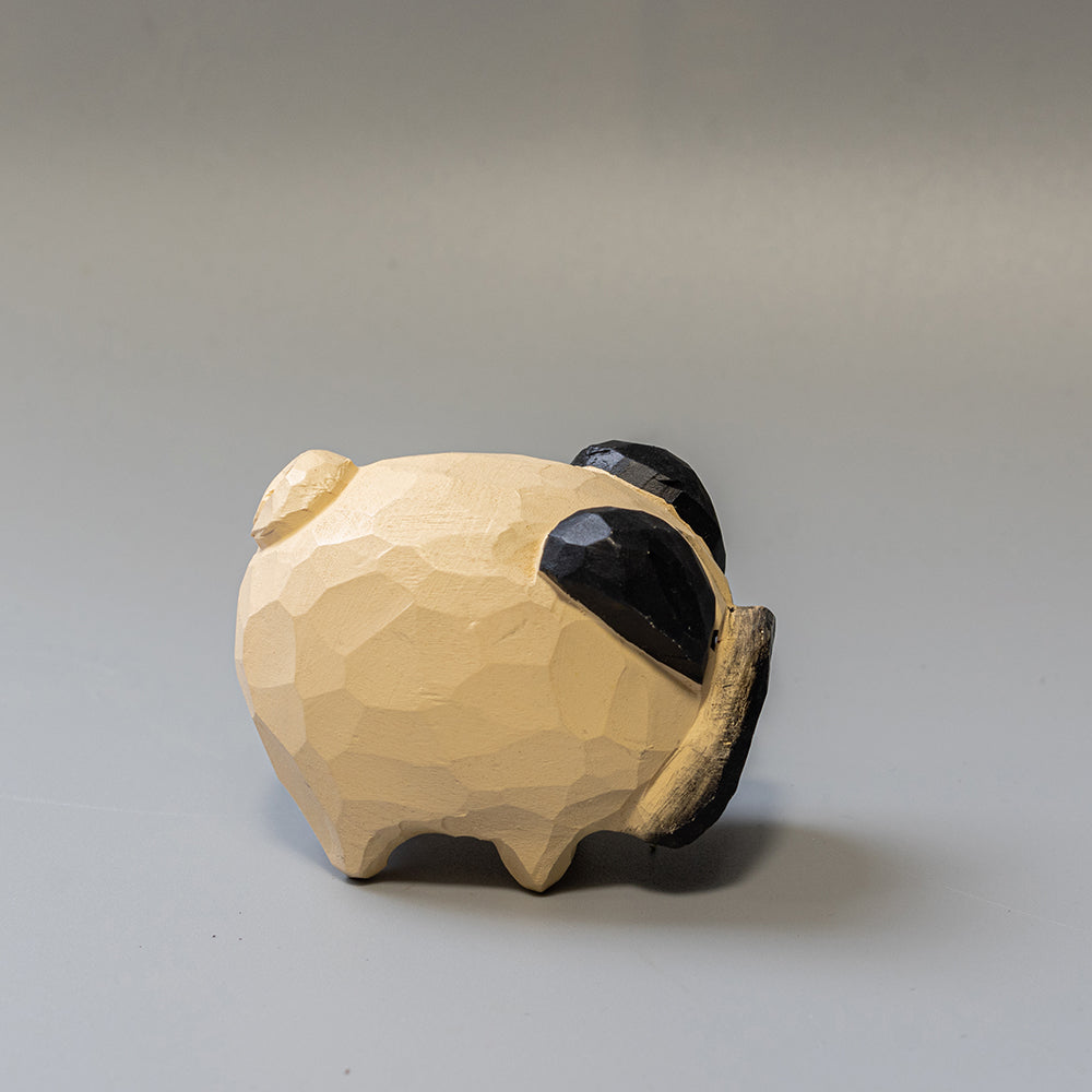 Hand-carved wooden Pug figurine with artfully rounded wrinkles and curled tail. 