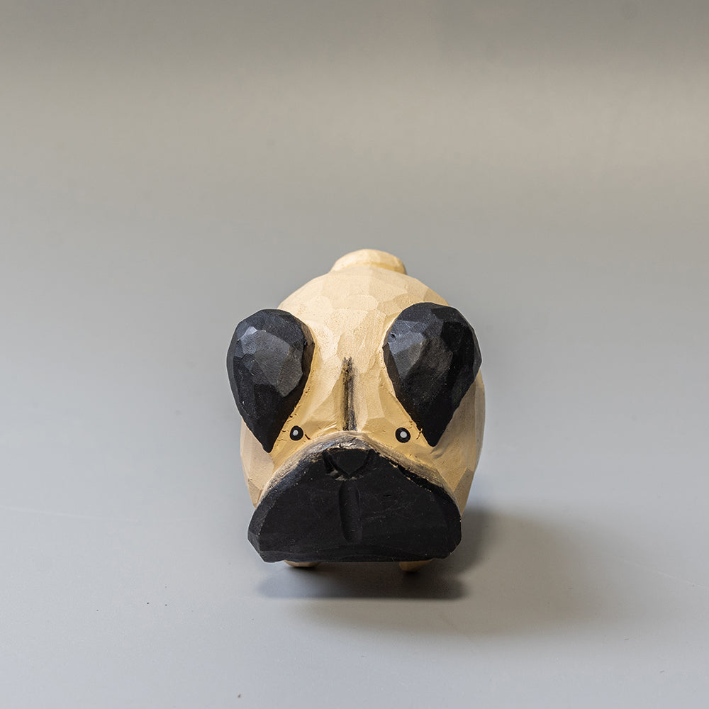 Hand-carved wooden Pug figurine with artfully rounded wrinkles and curled tail. 