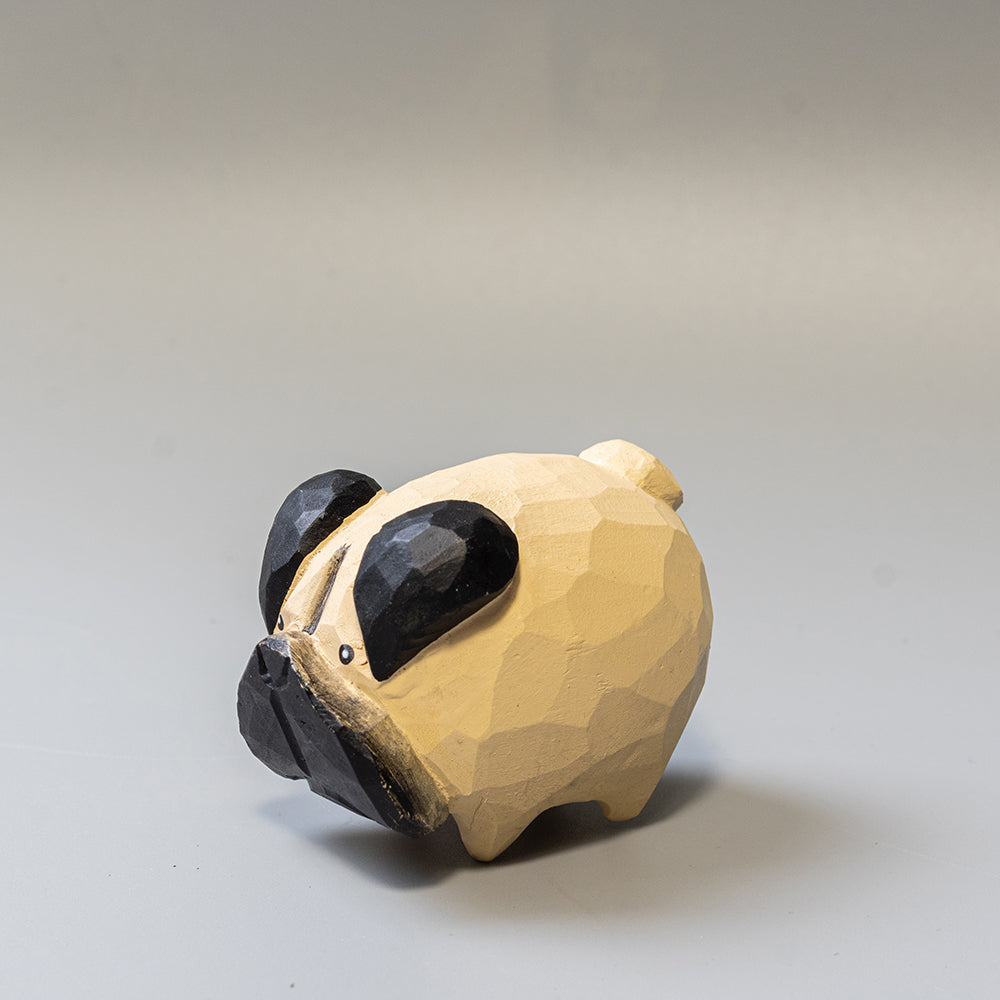 Hand-carved wooden Pug figurine with artfully rounded wrinkles and curled tail. 