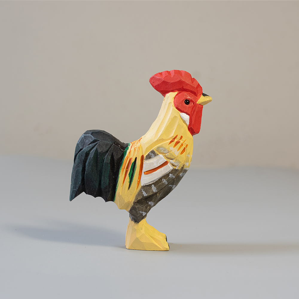 Colorful rooster figurine on a plain background