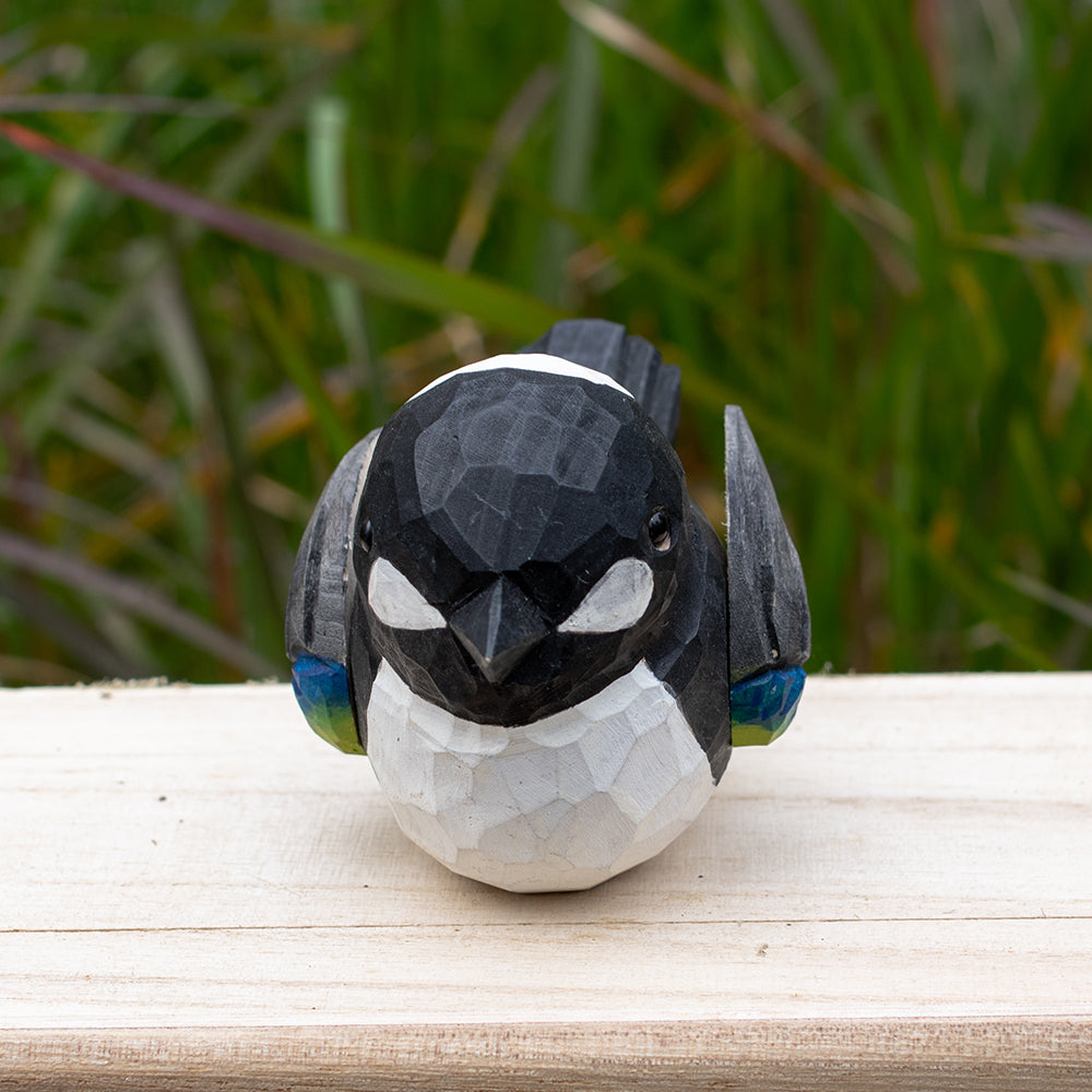 Artistic hand-carved wooden magpie figurine in bold black and white tones from the Odd Flocks series.