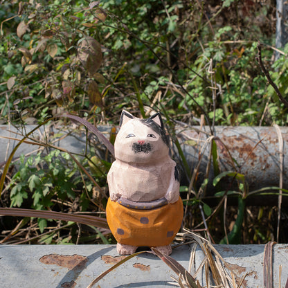 Hand carved wood figurine of a nomadic cat in patterned trousers. Unique carved wood figure, traditional wood art, detailed wooden figurine, high quality wood carving.