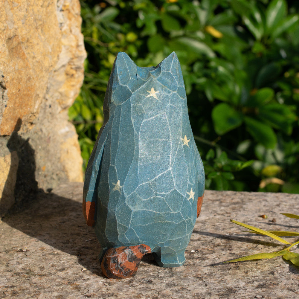 Hand-carved wooden figurine of a tabby cat in starry pajamas, whimsical decor for cat lovers.