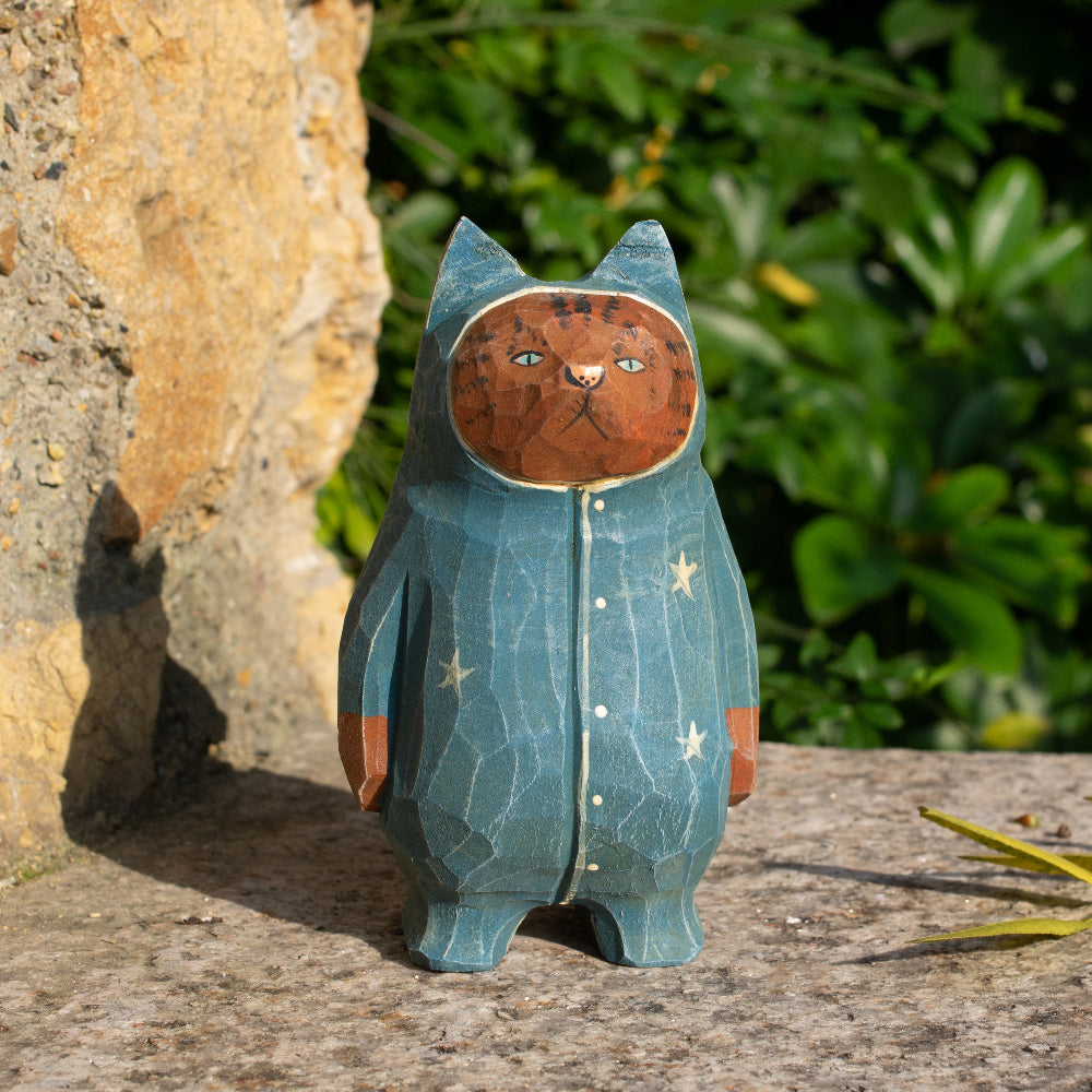 Hand-carved wooden figurine of a tabby cat in starry pajamas, whimsical decor for cat lovers.