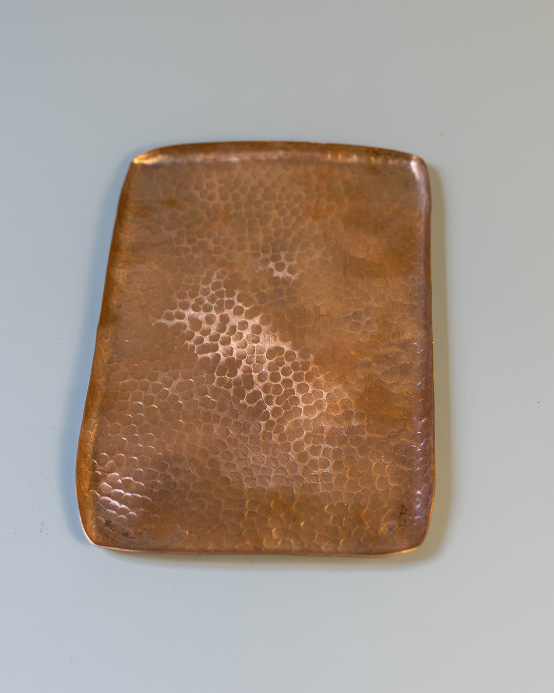 A rectangular, hand-hammered solid copper tray with a textured Tsuchime surface on a white background.