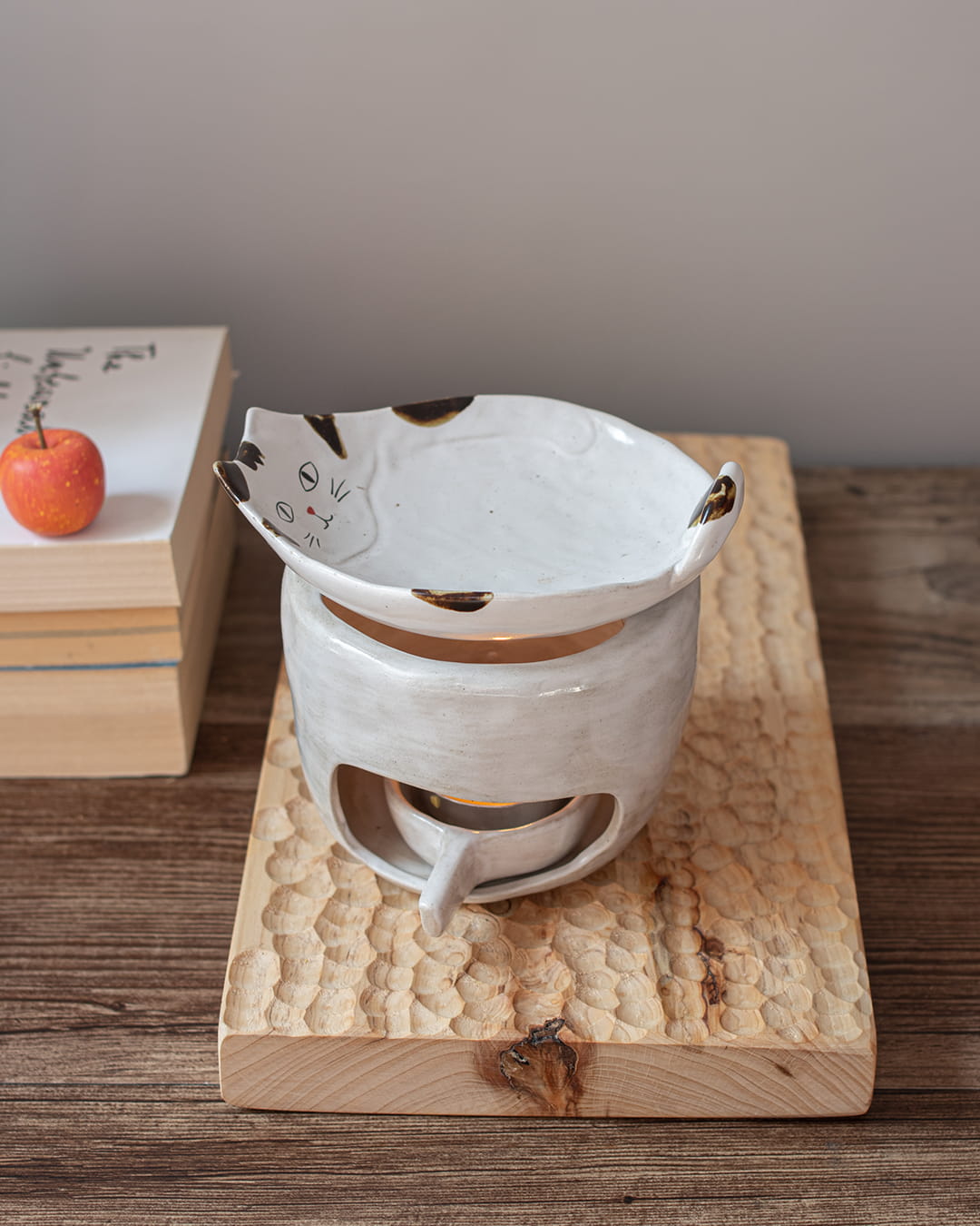 A rectangular, solid wood tray with a deep, hand-chiseled honeycomb texture, shown standing vertically on a dark wood surface.