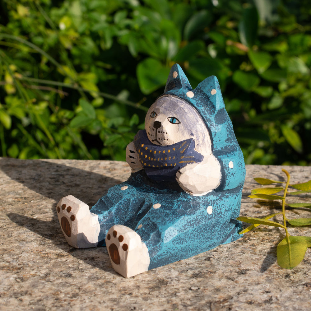 Hand-carved wooden cat figurine phone stand holding a fish, a functional decor piece for cat lovers.