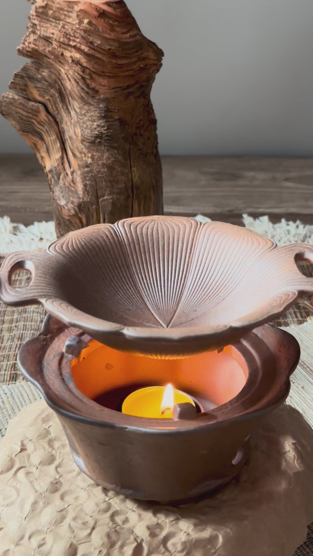 A rustic, two-piece ceramic aromatic warmer made from dark Aged Ore Clay.