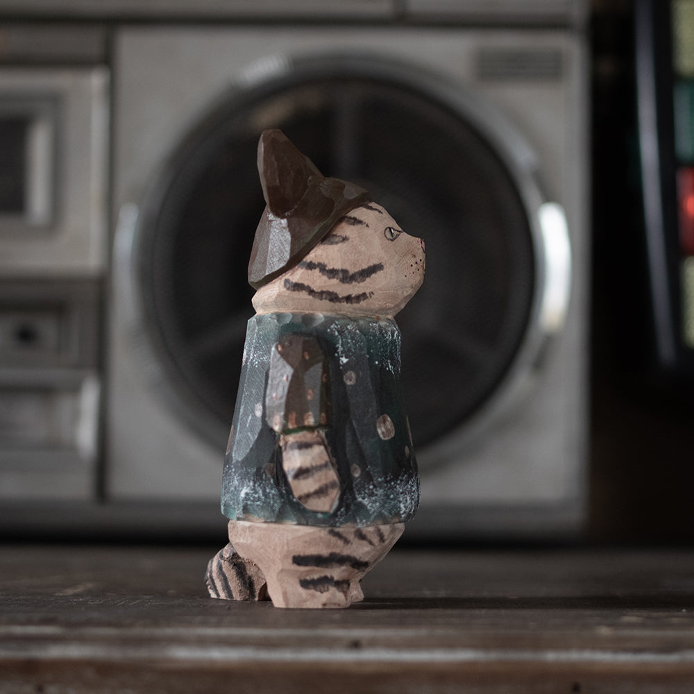 Hand-carved wooden figurine of a tabby cat dressed as a theme-park goer, ideal for sports fans and cat lovers.